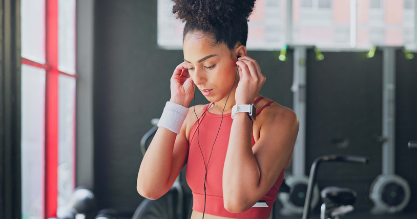 Gospel Songs Released In 2024 - Woman, gym and earphones for music, thinking and listening for inspiration to workout for wellness. African girl, audio streaming subscription and hearing for exercise, training or fitness with sound