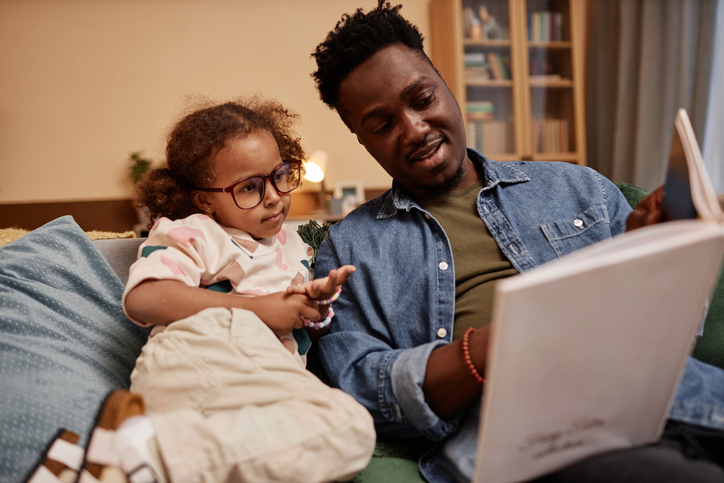 Father and Cute Daughter Reading Book