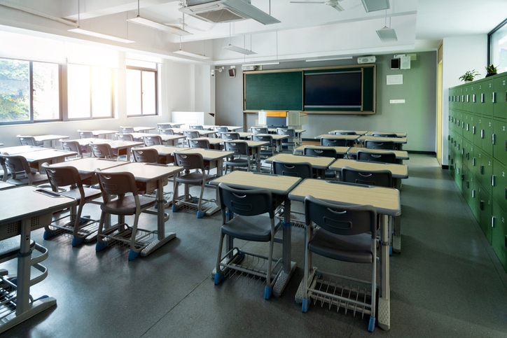 Empty classroom with desks and chairs