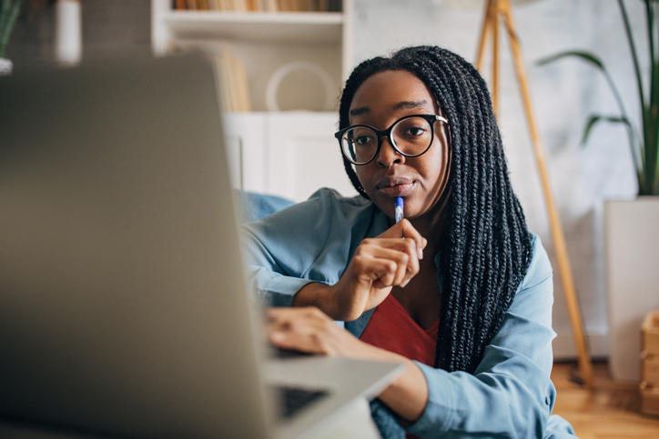 Focused professional working from home on laptop