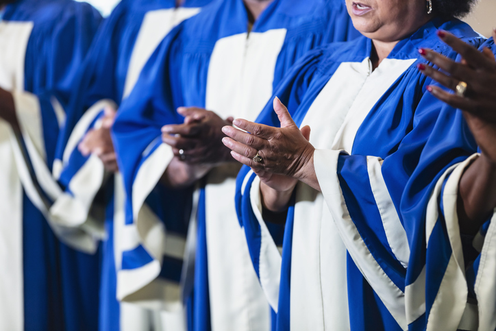 Cropped view of black men and women singing in choir
