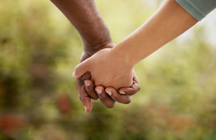 black wellness business - Closeup of couple interlocking their fingers and holding hands while bonding in the garden at home.