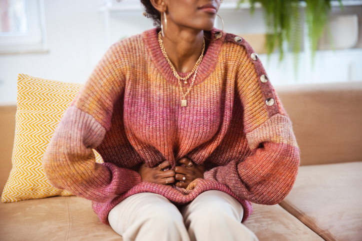 Gen Z young woman sufering stomach ache anxiety disorder