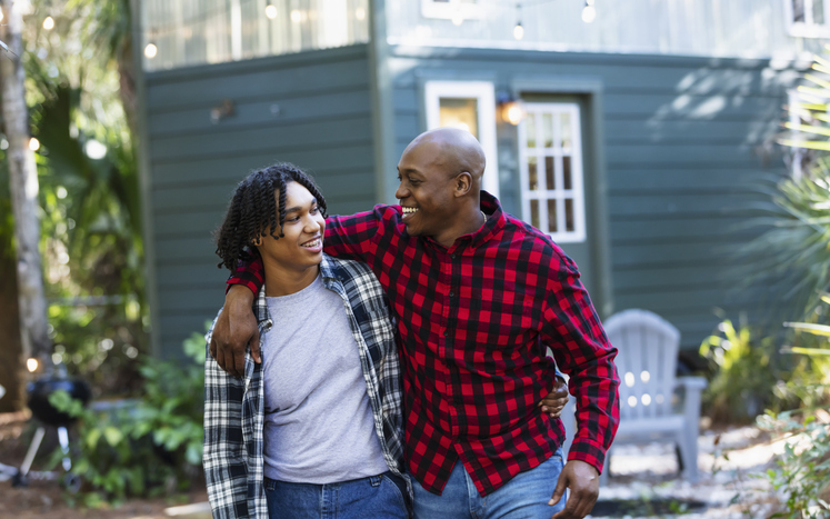 gift ideas for father's day - Father and teenage son walking together outside home