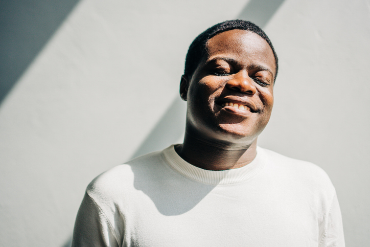 Close up of happy black man with closed eyes.