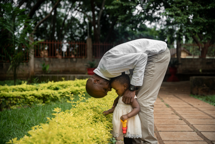 heavenly father sacrifices - African father and girl exploring and learning in a park