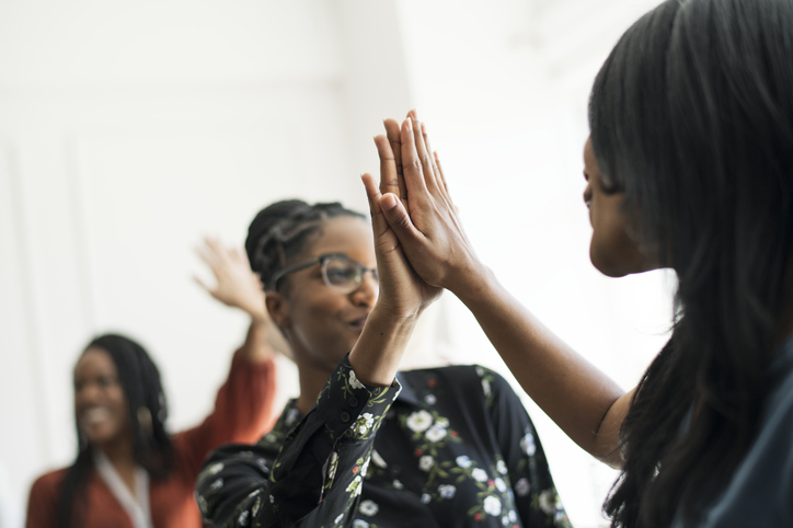 Businesswomen giving each other a high five