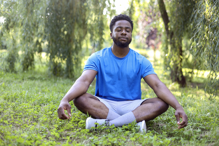 Young man meditating in nature
