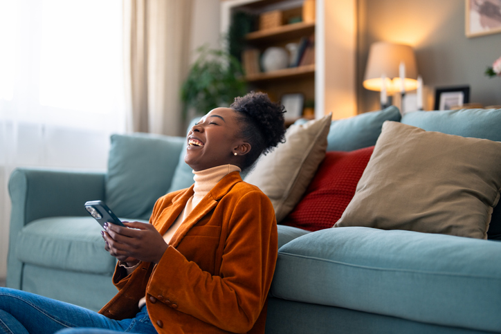 tiktok trend sour candy anxiety - Woman feeling very happy after reading a message on her cellphone