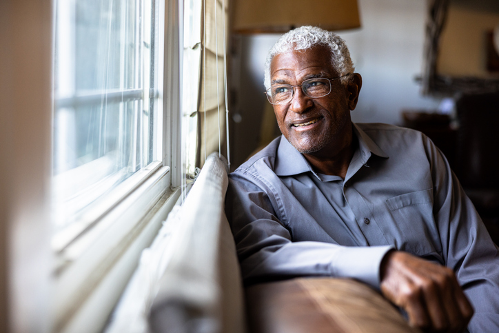 Detect Alzheimer’s Faster - Portrait of a senior black man at home at a window