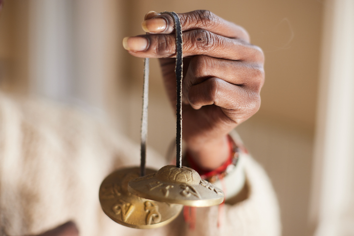 Mindful Meditation: Close-Up of Woman's Hand with Tibetan Cymbals Meditation Bells - frequency healing