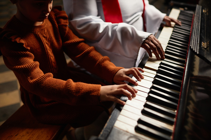 gospel music god's love - Woman from the church choir teaching girl to play piano