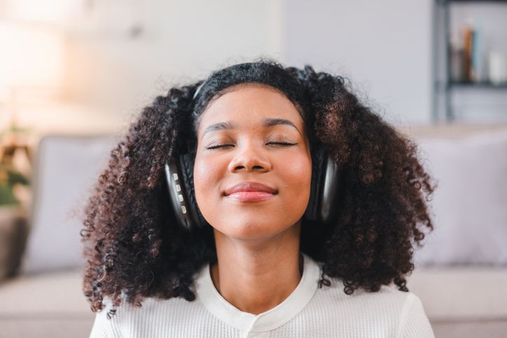 songs of thanksgiving - Close-up of African American Woman Relaxing with Headphones.