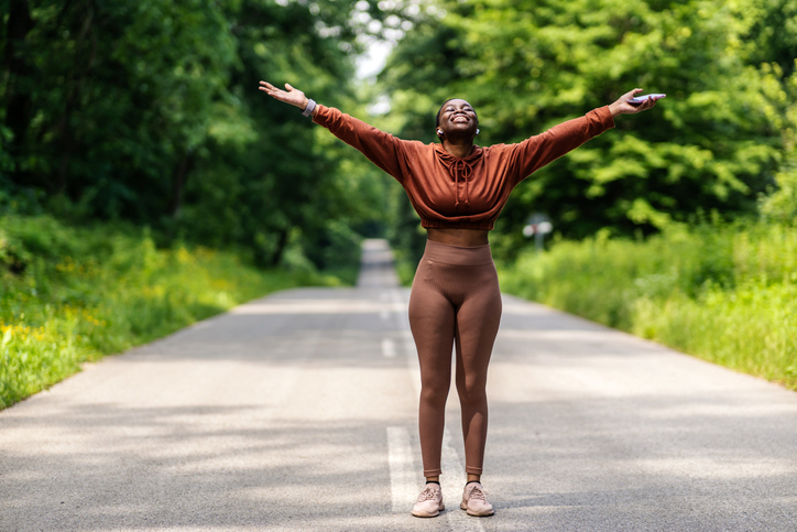 Shot of a carefree young woman enjoying the outdoors. Cropped shot of an attractive young sportswoman cheering in celebration outside.