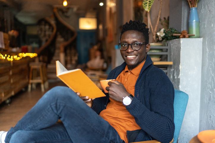 Handsome black man reading a book