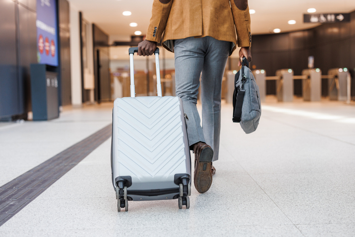 can travel slow the aging process - Rear view of a business traveler on the move