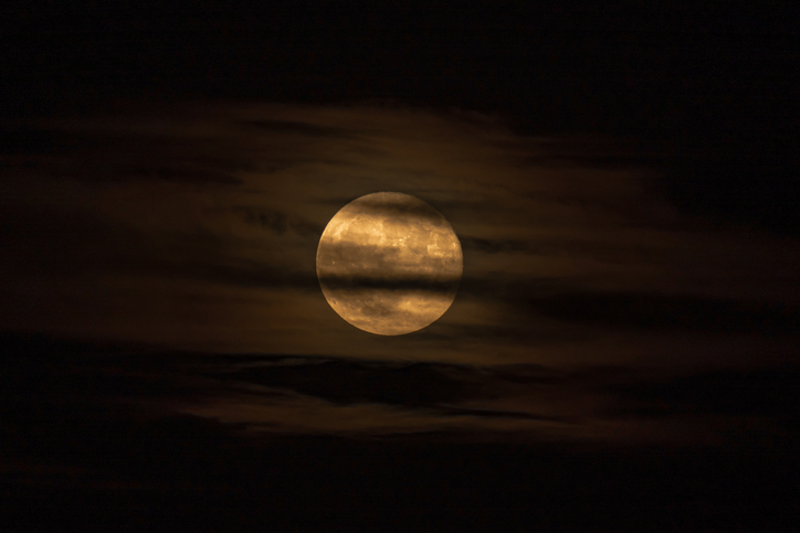 new moon love rituals - moon behind the clouds