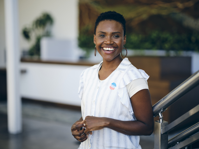 Woman in an Office with I VOTED Sticker