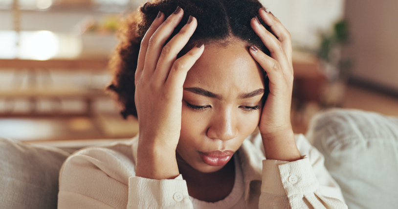 How to Stop Self-Sabotaging - African, woman and stress with depression at house for financial news, headache and anxiety challenge of debt. Girl, breathing and thinking of trauma memory, mental health fear and bankruptcy crisis