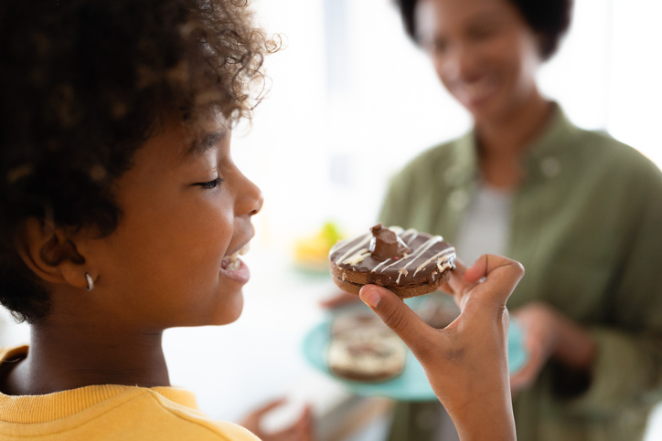 African American girl eating chocolate cookie