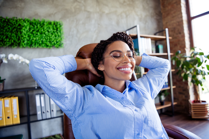 boundaries Spiritual Well-Being - Relaxed businesswoman enjoying break at work in modern office setting