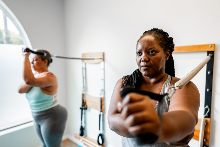 Mature women exercising at a pilates studio
