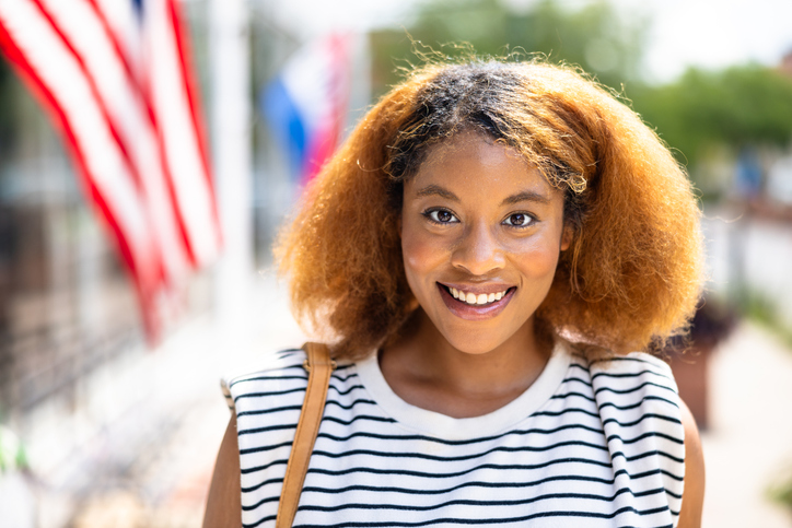 Portrait of a beautiful black woman in front of an American Flag