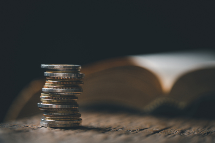 2819 church - One tenth or tithe is basis on which Bible teaches us to give one tenth of first fruit to God. coins with Holy Bible. Biblical concept of Christian offering, generosity, and giving tithes in church.