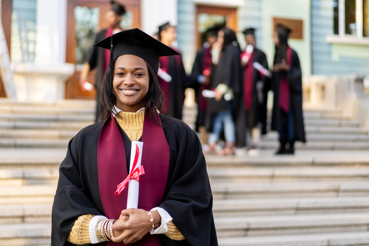 A girl graduate with a scroll in her hands